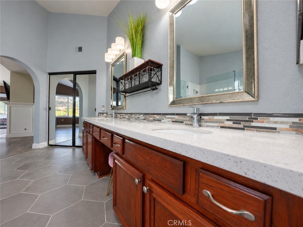 The upstairs Master Bedroom has a double sink granite countertop and walk-in closet with sliding doors - 25652 Nottingham Court, Laguna Hills CA 92653 - photo 22