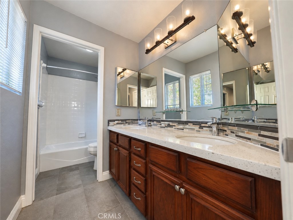 Upstairs double-sink bathroom with granite counters - 25652 Nottingham Court, Laguna Hills CA 92653 - photo 25