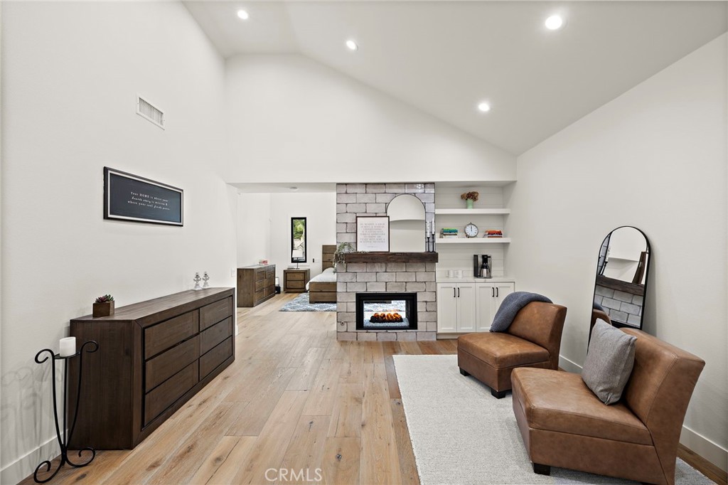 Sitting area with dual sided fireplace in primary suite is the perfect home office, gym or reading room. - 27562 Lost Trail Drive, Laguna Hills CA 92653 - photo 26