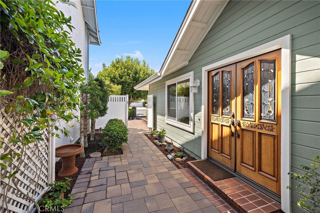 Gorgeous stained glass windows enhance the beautiful wood front doors - 30 Oxbow Creek, Laguna Hills CA 92653 - photo 4