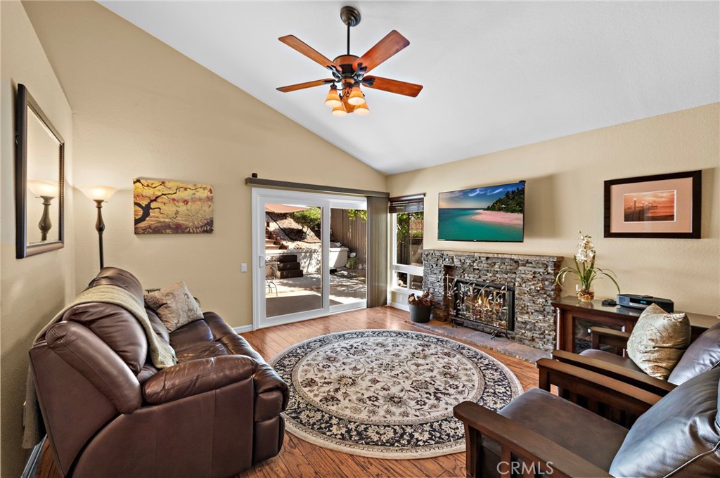 Wonderful view of outdoor patio and terraced garden from living area enhanced by a stacked stone fireplace - 30 Oxbow Creek, Laguna Hills CA 92653 - photo 10
