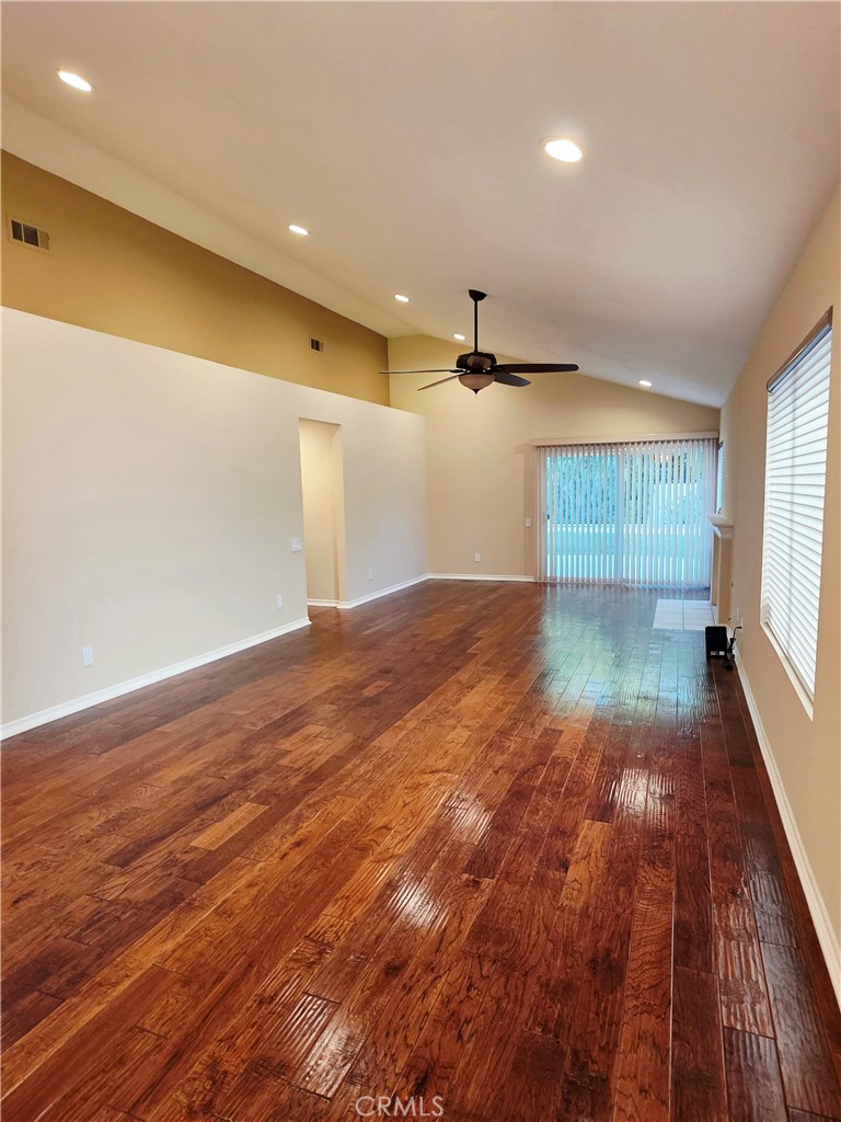 Spacious great room with recessed lighting, beautiful flooring, and gas fireplace. Perfect for entertaining or enjoying - 41 Jasmine Creek, Laguna Hills CA 92653 - photo 4