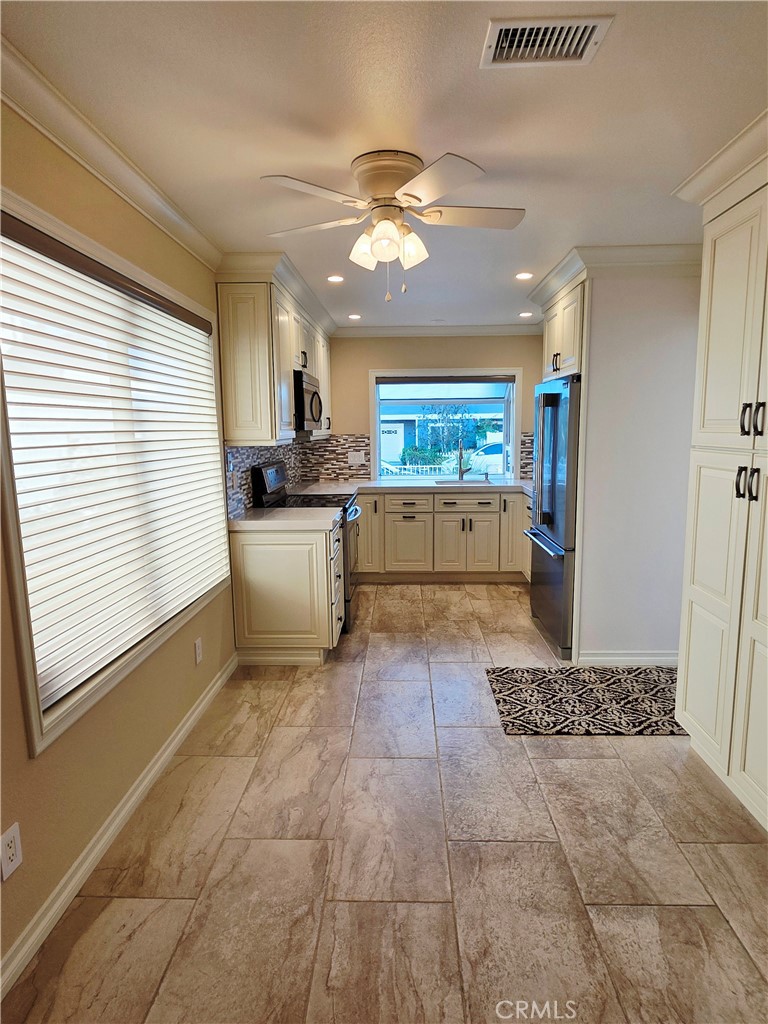 Breakfast nook with ceiling fan and extra cabinetry. - 41 Jasmine Creek, Laguna Hills CA 92653 - photo 5