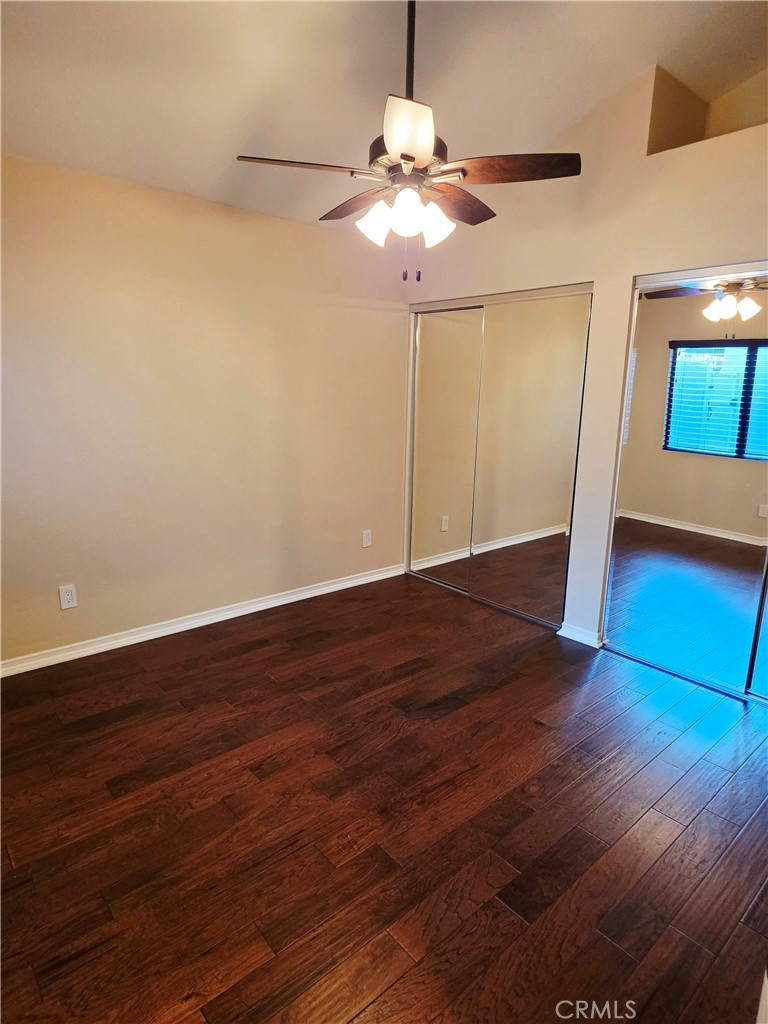 Secondary bedroom with high ceilings, mirror wardrobe doors, ceiling fan. - 41 Jasmine Creek, Laguna Hills CA 92653 - photo 10