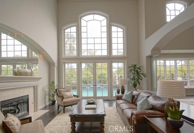 Main floor living room with 20 ft. ceiling, open to formal dining and family room, with beautiful views of luxurious bac - 10 Poppy Hills Road, Laguna Niguel CA 92677 - photo 1