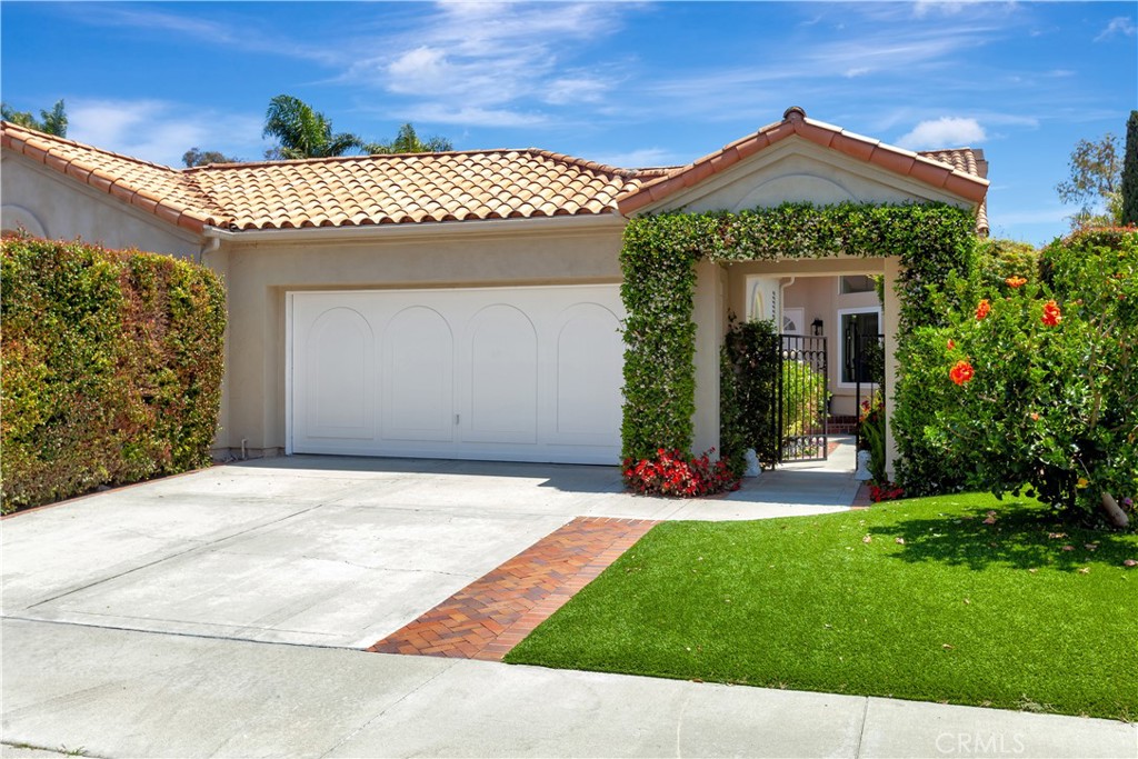 Well landscaped front yard with artificial turf lawn for lower maintenance and water costs. - 13 Chamonix, Laguna Niguel CA 92677 - photo 1