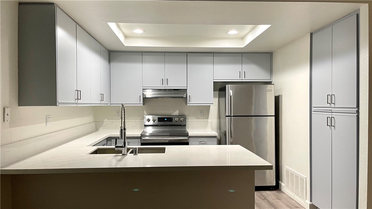 Kitchen opens to Great Room. Pantry on the right. Stainless appliances. Recessed lights. - 15 Aruba, Laguna Niguel CA 92677 - photo 7