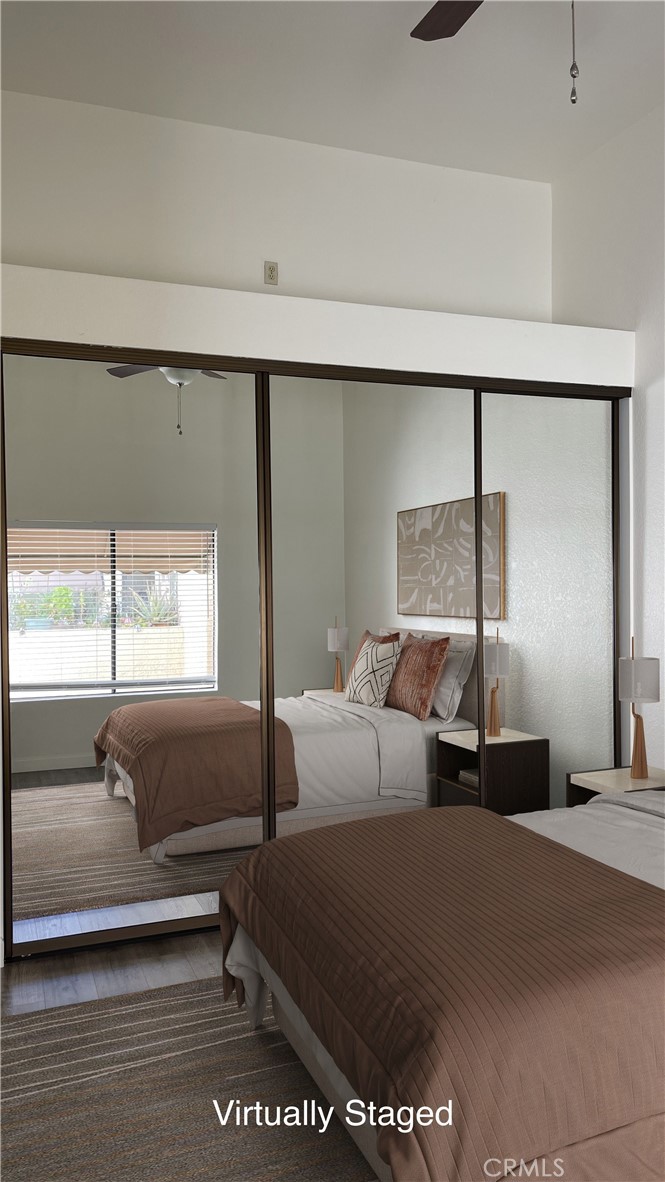 Virtually Staged Primary Bedroom - large closet space with closet organizers, vaulted ceiling and a ceiling fan. - 15 Aruba, Laguna Niguel CA 92677 - photo 20