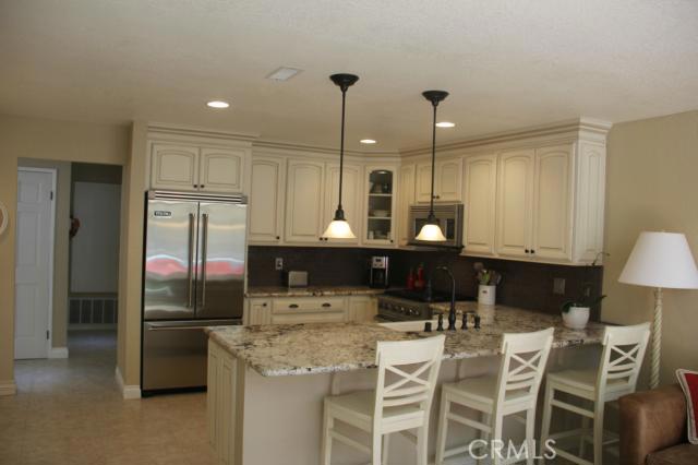 Custom built tall cabinets with Granite counters and Tile floors. Stainless appliances and farm style sink. - 15 Columbus, Laguna Niguel CA 92677 - photo 1