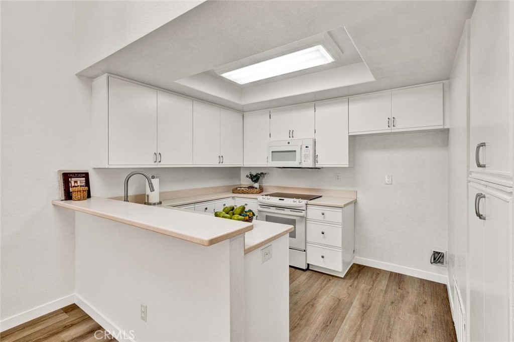 Freshly painted kitchen cabinets with modern hardware and a bright, updated finish. - 22 Aruba, Laguna Niguel CA 92677 - photo 8