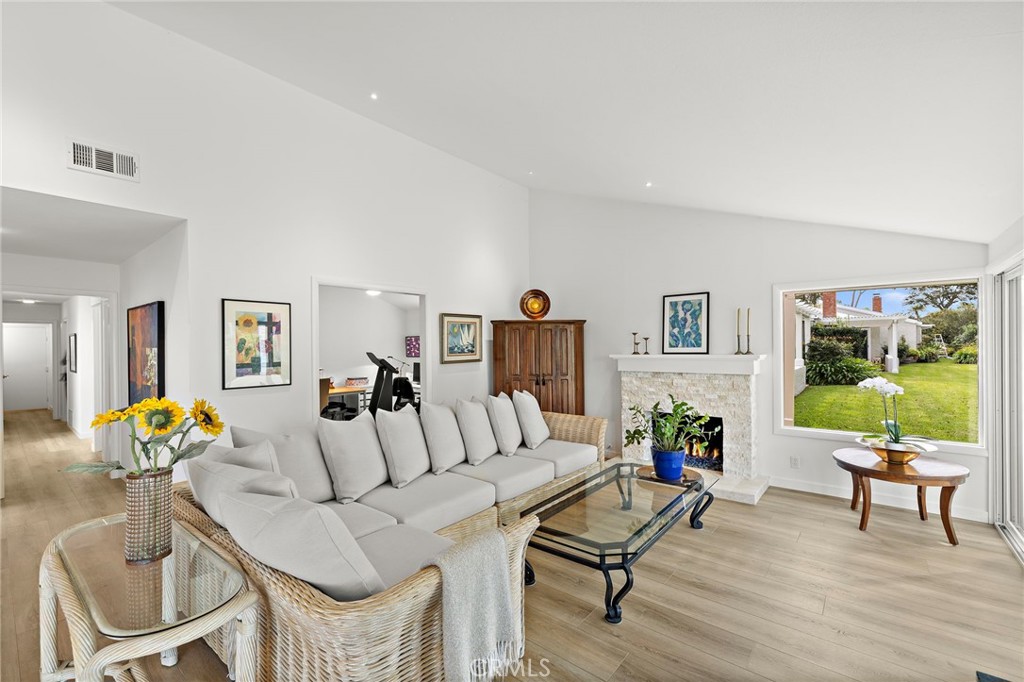 Relax in the spacious family room, anchored by a cozy fireplace and framed by picture-perfect views of the landscaped si - 22773 Mariano, Laguna Niguel CA 92677 - photo 1