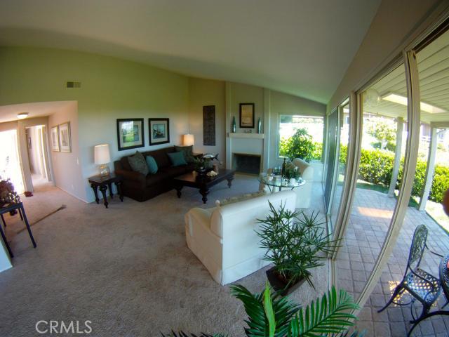 LIVING ROOM OPENS TO AN OUTDOOR COVERED PATIO WITH OCEAN AND CITY LIGHT VIEWS. - 23062 Torina Lane, Laguna Niguel CA 92677 - photo 1