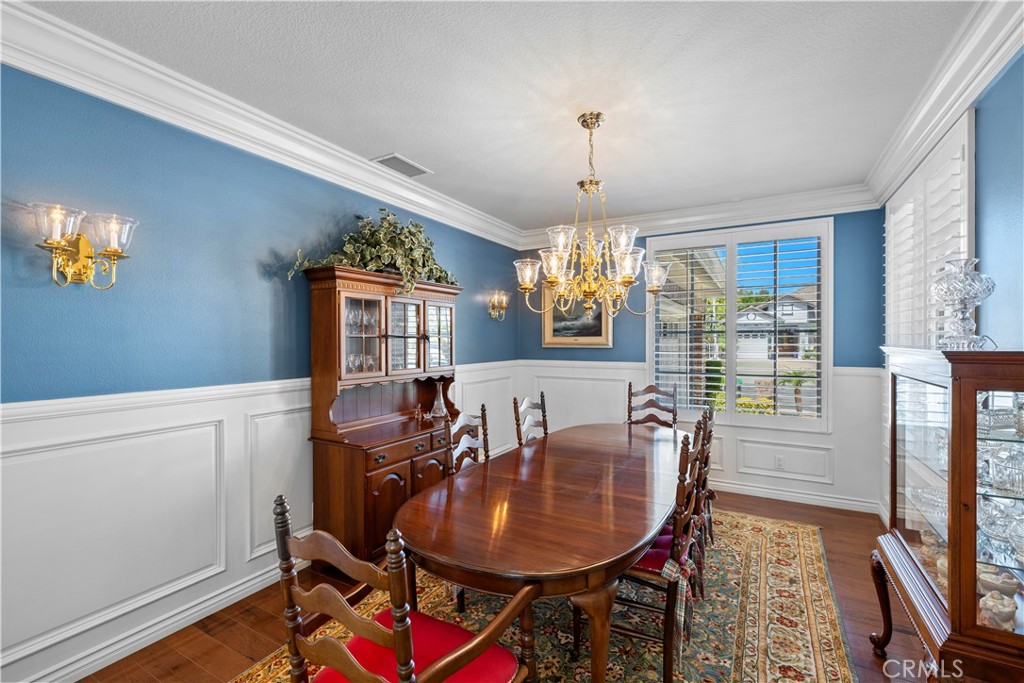 Stunning Formal Dining Room with Gorgeous Crown Molding, Intricate Wainscoting and Beautiful Plantation Shutters. - 23611 Trinidad Lane, Laguna Niguel CA 92677 - photo 7