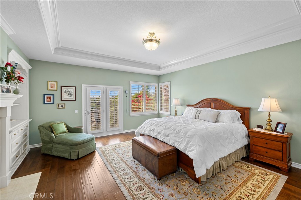 Stunning Primary Suite with Exquisite Crown Molding, Plantation Shutters, Custom Built-In's and Elegant Fireplace. - 23611 Trinidad Lane, Laguna Niguel CA 92677 - photo 23