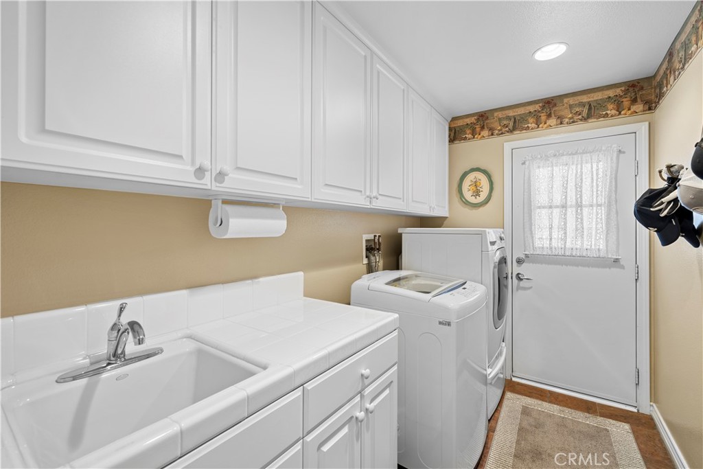 Lovely Laundry Room on Main Floor with Sink and Cabinetry. - 23611 Trinidad Lane, Laguna Niguel CA 92677 - photo 39