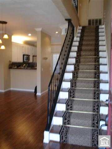 Looking from the front door into living area & up stairs - hardwood floors, designer runner over wood stairs - 23643 WALTERS Circle, Laguna Niguel CA 92677 - photo 1