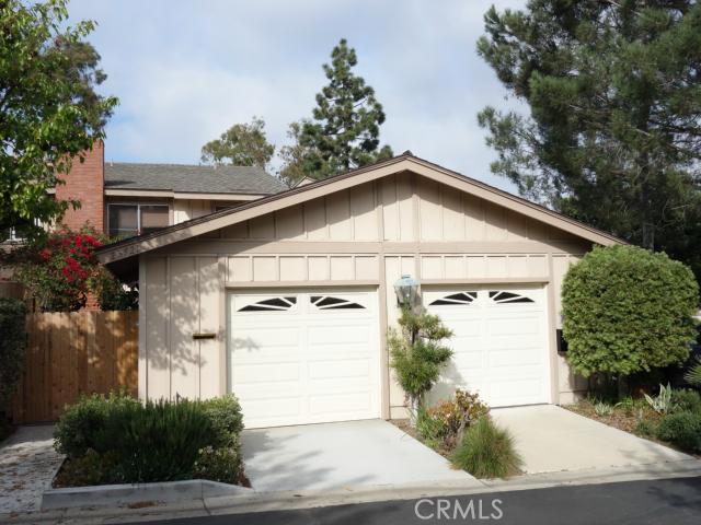 One car garage on left. Another designated parking space in adjacent parking lot area. Entrance courtyard wooden gate is - 23721 Porpoise, Laguna Niguel CA 92677 - photo 1