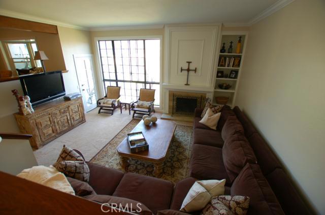 Large, sunken living room with French door to deck and canyon view out of the large window. - 23975 Catamaran Way 13, Laguna Niguel CA 92677 - photo 1