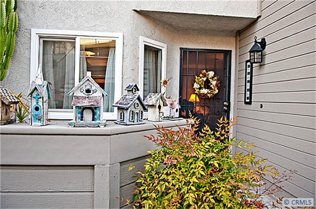 Front door with a welcoming patio. - 24247 AVENIDA DE LAS FLORES 110, Laguna Niguel CA 92677 - photo 1