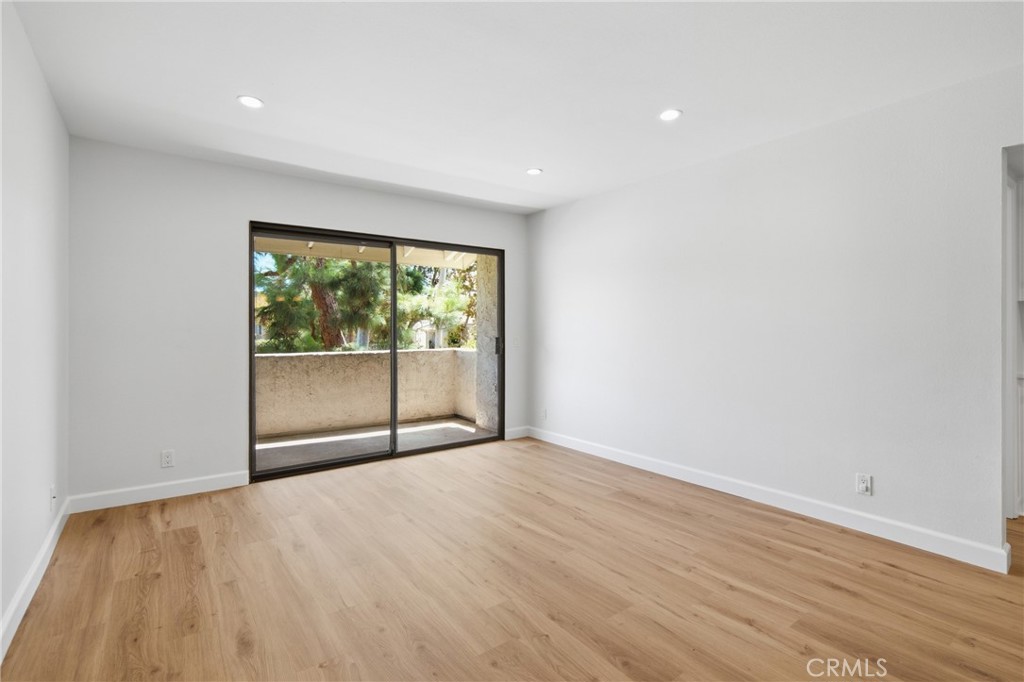 The living area opens to a private patio with peaceful park and greenbelt views—a standout feature of this home. - 24278 El Pilar, Laguna Niguel CA 92677 - photo 7