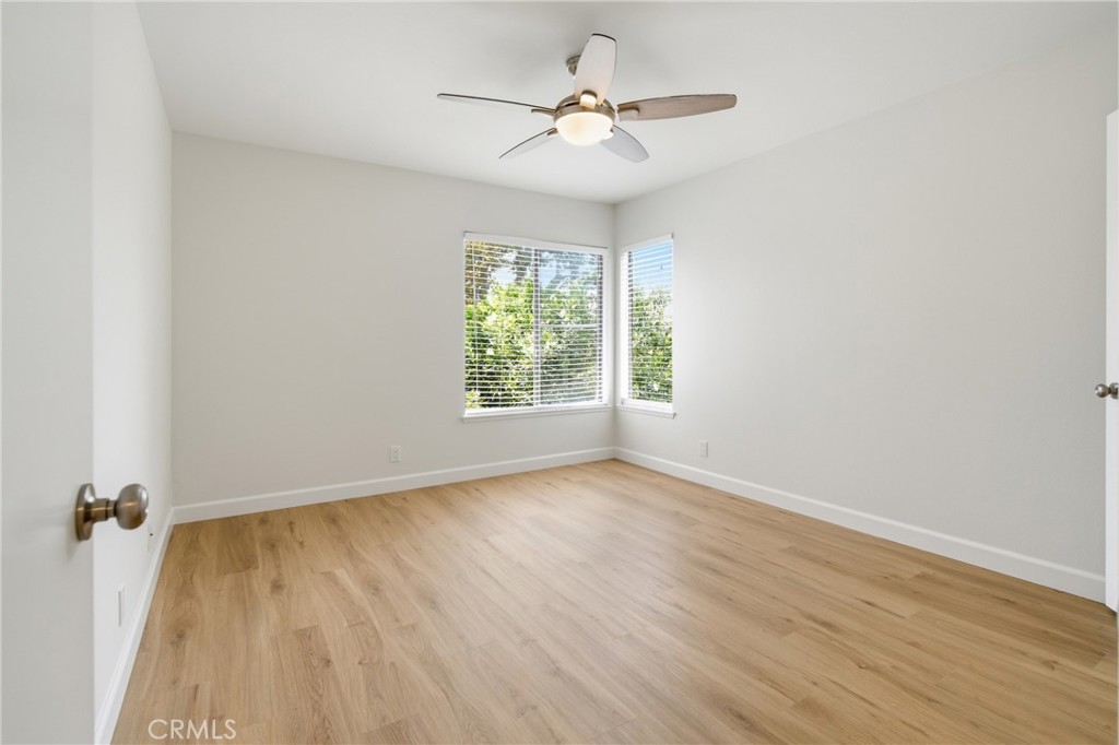 Spacious primary bedroom with new luxury vinyl plank flooring, fresh paint and plenty of natural light. - 24278 El Pilar, Laguna Niguel CA 92677 - photo 10