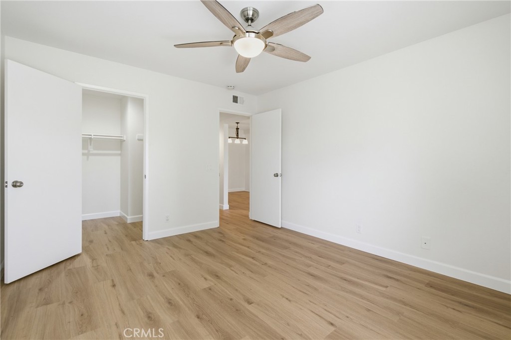 Comfortable primary bedroom with a generous walk-in closet offering excellent storage. - 24278 El Pilar, Laguna Niguel CA 92677 - photo 11