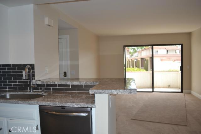 Living room area with bar stool area in kitchen - 24297 El Pilar, Laguna Niguel CA 92677 - photo 1