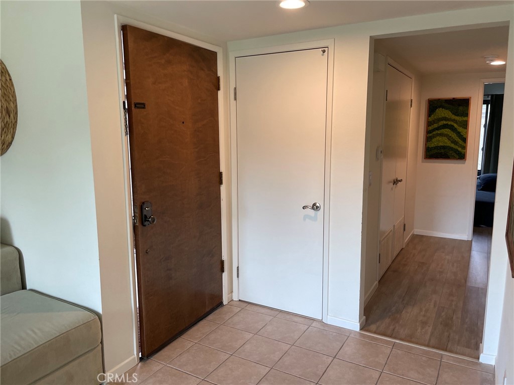 Entry to condo with coat closet - 24298 El Pilar, Laguna Niguel CA 92677 - photo 6