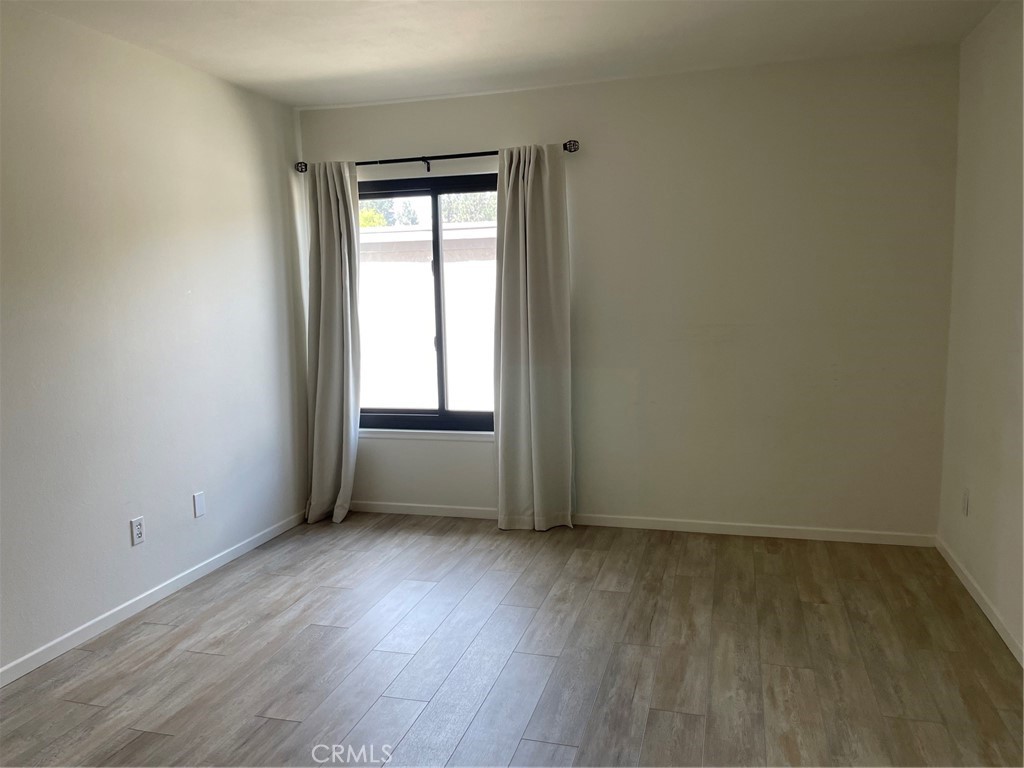 Main bedroom with vinyl planks flooring - 24298 El Pilar, Laguna Niguel CA 92677 - photo 22