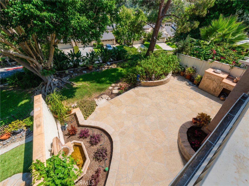 Elevated balcony view overlooking mature landscaping, with neighboring homes set below the rear slope for added privacy. - 24356 Hillview, Laguna Niguel CA 92677 - photo 28