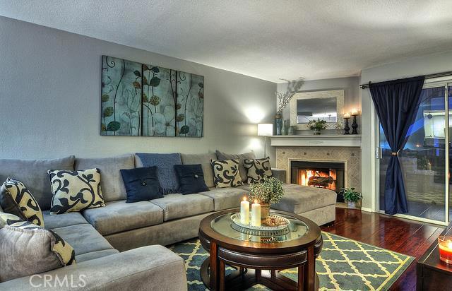 Spacious living room with remodeled tile fireplace and hardwood flooring. - 24458 Kathleen Drive, Laguna Niguel CA 92677 - photo 1