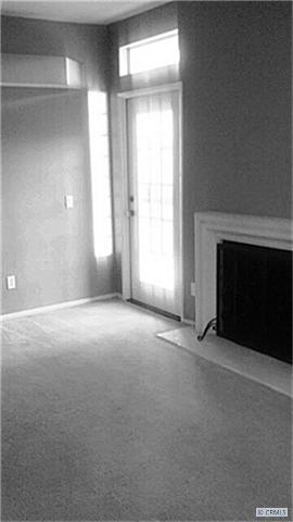 Living room with fireplace and entrance to private patio - 25072 LEUCADIA Street A, Laguna Niguel CA 92677 - photo 1
