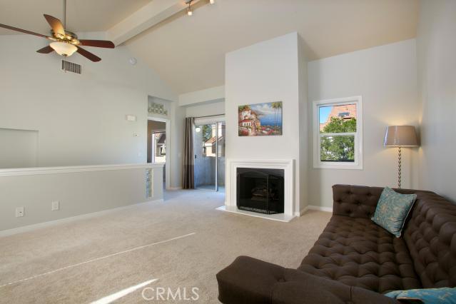 Expansive Open Concept Living area with architecturally inspired ceiling, gas fireplace, brand new ceiling fan and light - 25102 Calle Playa F, Laguna Niguel CA 92677 - photo 1