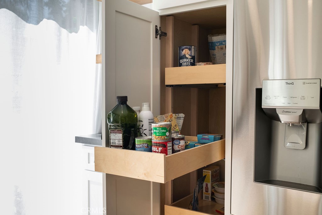 Custom pull-out shelves in pantry makes for easy access to shelf-stable food. - 25655 Paseo La Cresta 47, Laguna Niguel CA 92677 - photo 16