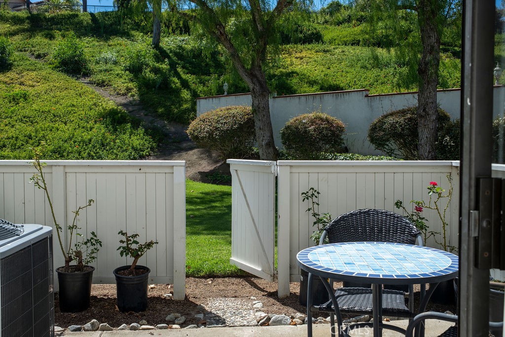 Patio view showing exit gate to greenbelt and landscaping. - 25655 Paseo La Cresta 47, Laguna Niguel CA 92677 - photo 23