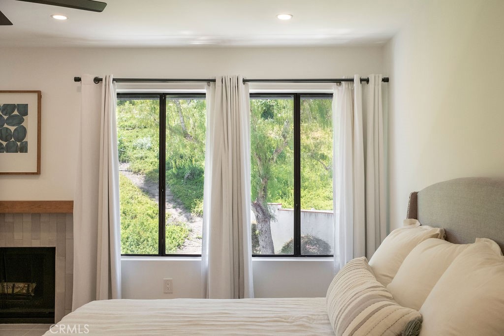 Fireplace and partial view of greenbelt. - 25655 Paseo La Cresta 47, Laguna Niguel CA 92677 - photo 29
