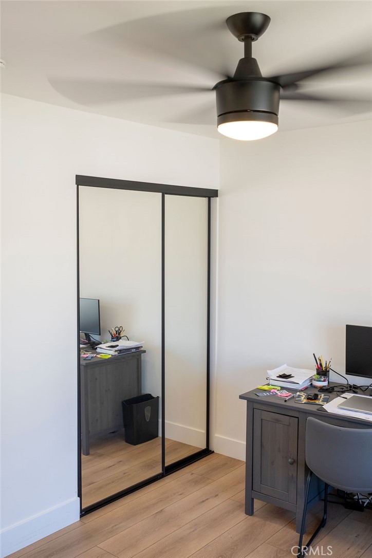 Secondary bedroom view showing mirrored wardrobe doors and ceiling fan. - 25655 Paseo La Cresta 47, Laguna Niguel CA 92677 - photo 36