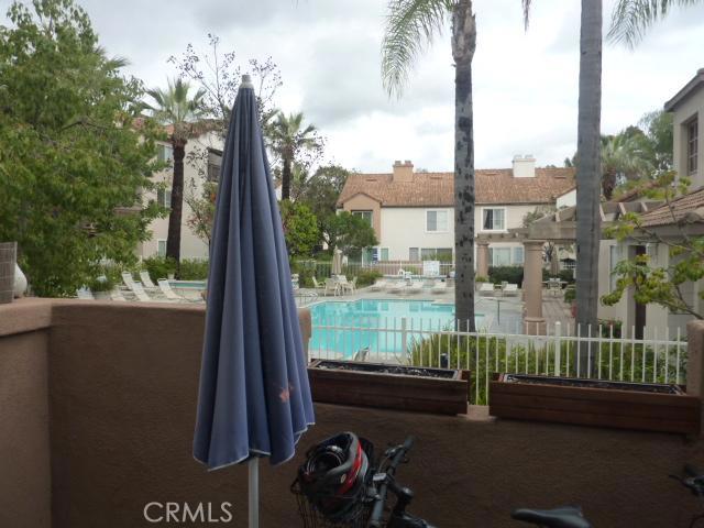 View of the community pool from the back patio and living/family room. - 28106 Caldaro, Laguna Niguel CA 92677 - photo 1
