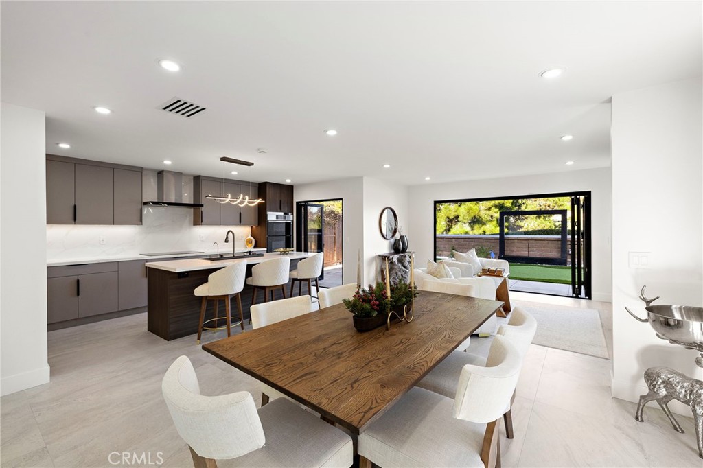 Contemporary kitchen open to dining and to back yard oasis via the aluminum bifold doors in both the kitchen and family - 28832 Calle Vista, Laguna Niguel CA 92677 - photo 1