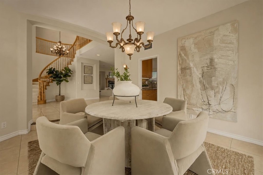 Refined dining space with a statement chandelier, and views of the grand staircase. - 28932 Drakes Bay, Laguna Niguel CA 92677 - photo 10