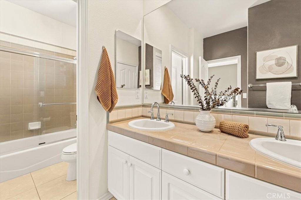 A thoughtfully designed Jack-and-Jill bath with dual vanities and a shower-tub combination, effortlessly connecting the - 28932 Drakes Bay, Laguna Niguel CA 92677 - photo 63