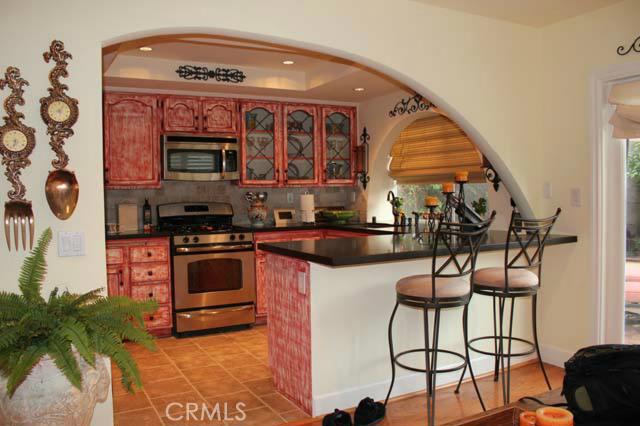 Fully upgraded Mediterranean style kitchen with custom archway, recessed lighting, and decorative tile flooring. - 29562 Crown Creek, Laguna Niguel CA 92677 - photo 1