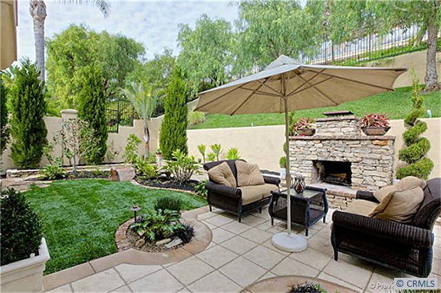 Serene, Tuscan inspired and professionally landscaped backyard with natural stone fireplace, built-in BBQ, Pepper trees, - 3 PILOS, Laguna Niguel CA 92677 - photo 1