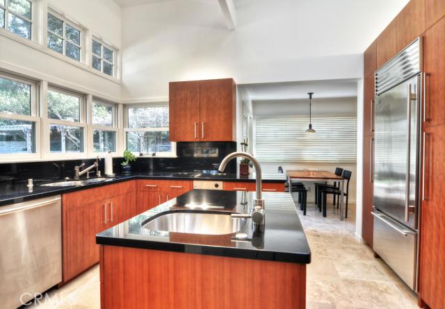 Custom quarter cut cherry wood kitchen and master bath cabinets with “Absolute Black” slab granite counter tops and back - 30751 Concord Lane, Laguna Niguel CA 92677 - photo 1