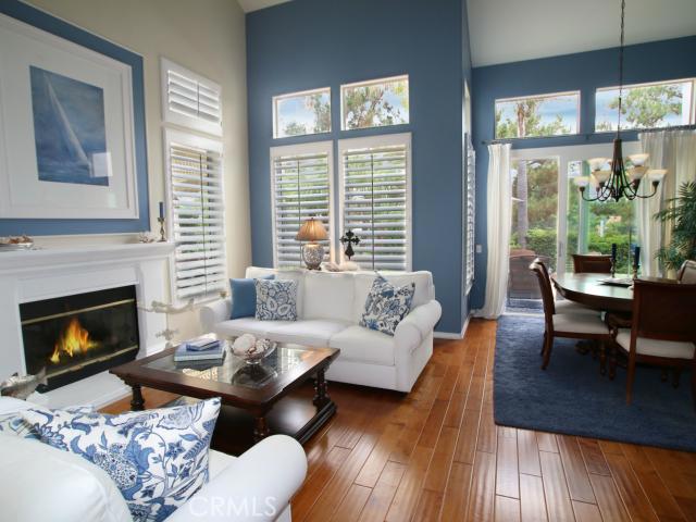Upon entering, 20' ceilings in the living room provide filtered natural light through tall windows with plantation shutt - 39 Siena, Laguna Niguel CA 92677 - photo 1