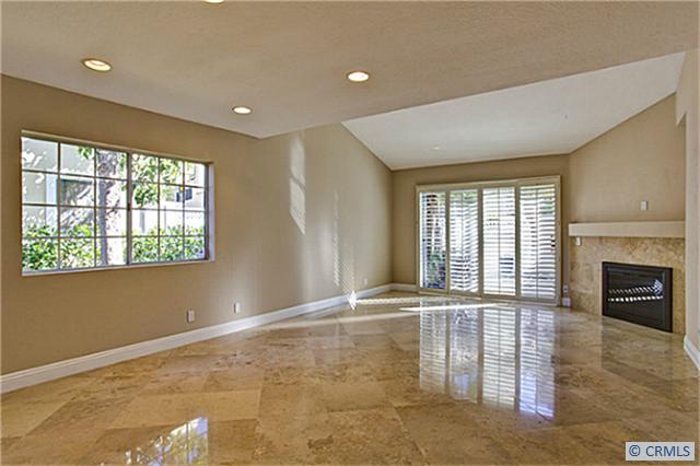 Living room with beautiful polished travertine floors and romantic fireplace. - 6 POINTE SAN PABLO 81, Laguna Niguel CA 92677 - photo 1