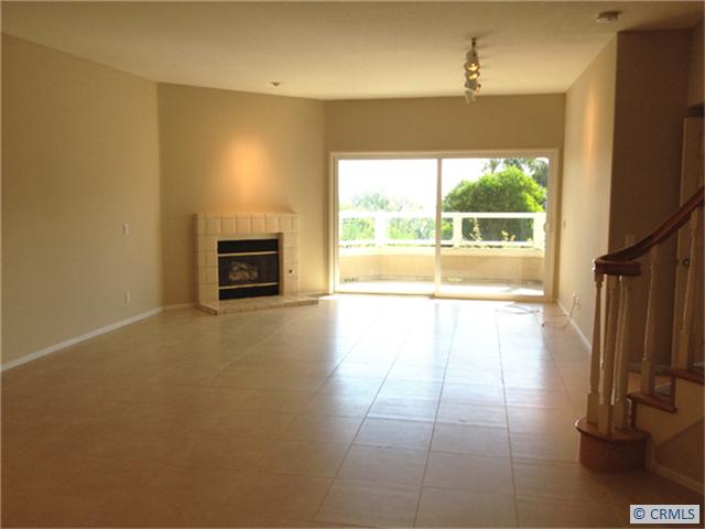 Lower Level Great Room with Fireplace , off Downstairs Master Bedroom. Tree view deck. - 66 MARSEILLE, Laguna Niguel CA 92677 - photo 1