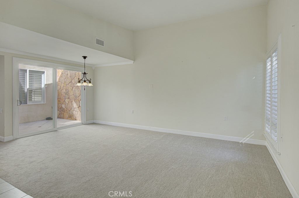 Spacious open living room/dining room area accommodates various configurations of large furnishings. - 2 Via Castilla E, Laguna Woods CA 92637 - photo 3