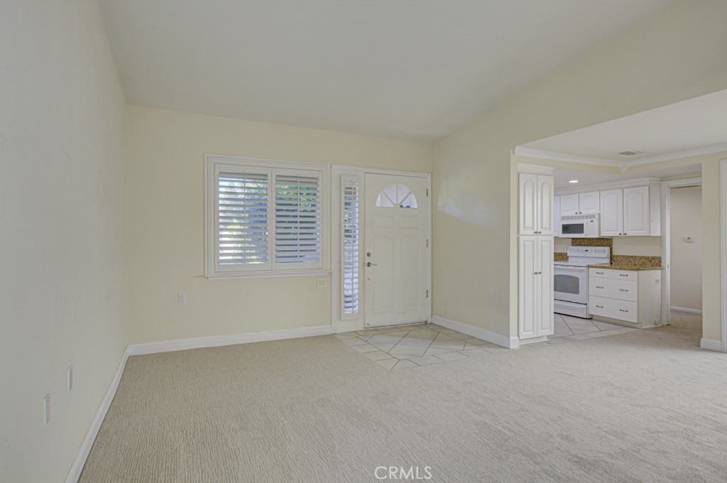 Another view of the living room looking back towards the front door and entry to the kitchen. - 2 Via Castilla E, Laguna Woods CA 92637 - photo 4