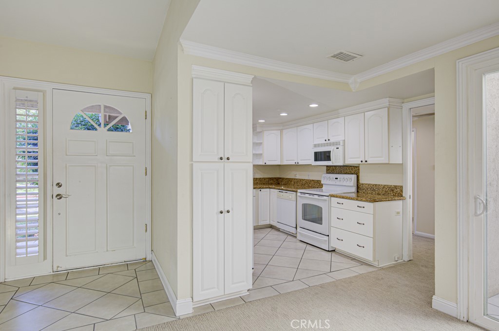 Front door and entry to the kitchen. - 2 Via Castilla E, Laguna Woods CA 92637 - photo 7